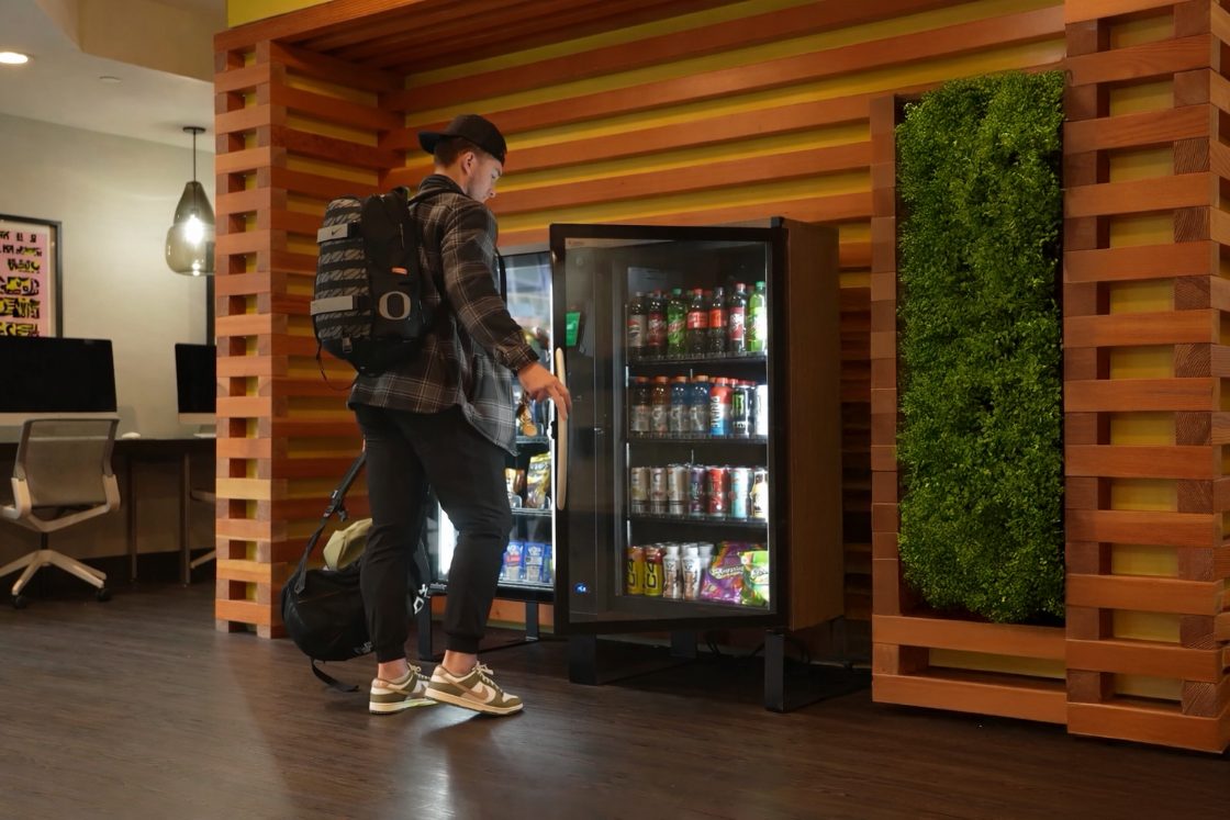 Resident using a micro-market in an apartment lobby